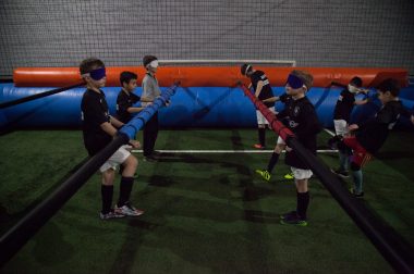 Plusieurs enfants lors d'une partie de babyfoot géant