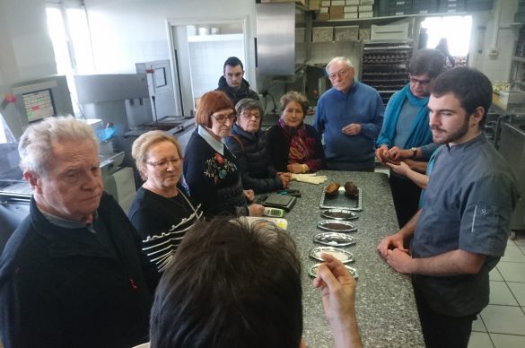 groupe de personnes autour d'une table de cuisine professionnelle. 