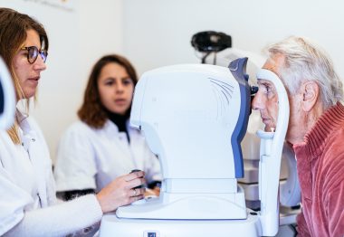 Une ophtalmologiste réalise des examens oculaires sur un patient dans le Bus du Glaucome de l'UNADEV, assistée de l'orthoptiste de l'UNADEV